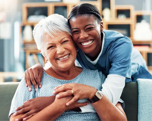 Senior, happy women with care giver in assisted living.