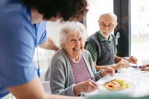 Elderly couple having lunch in their own home